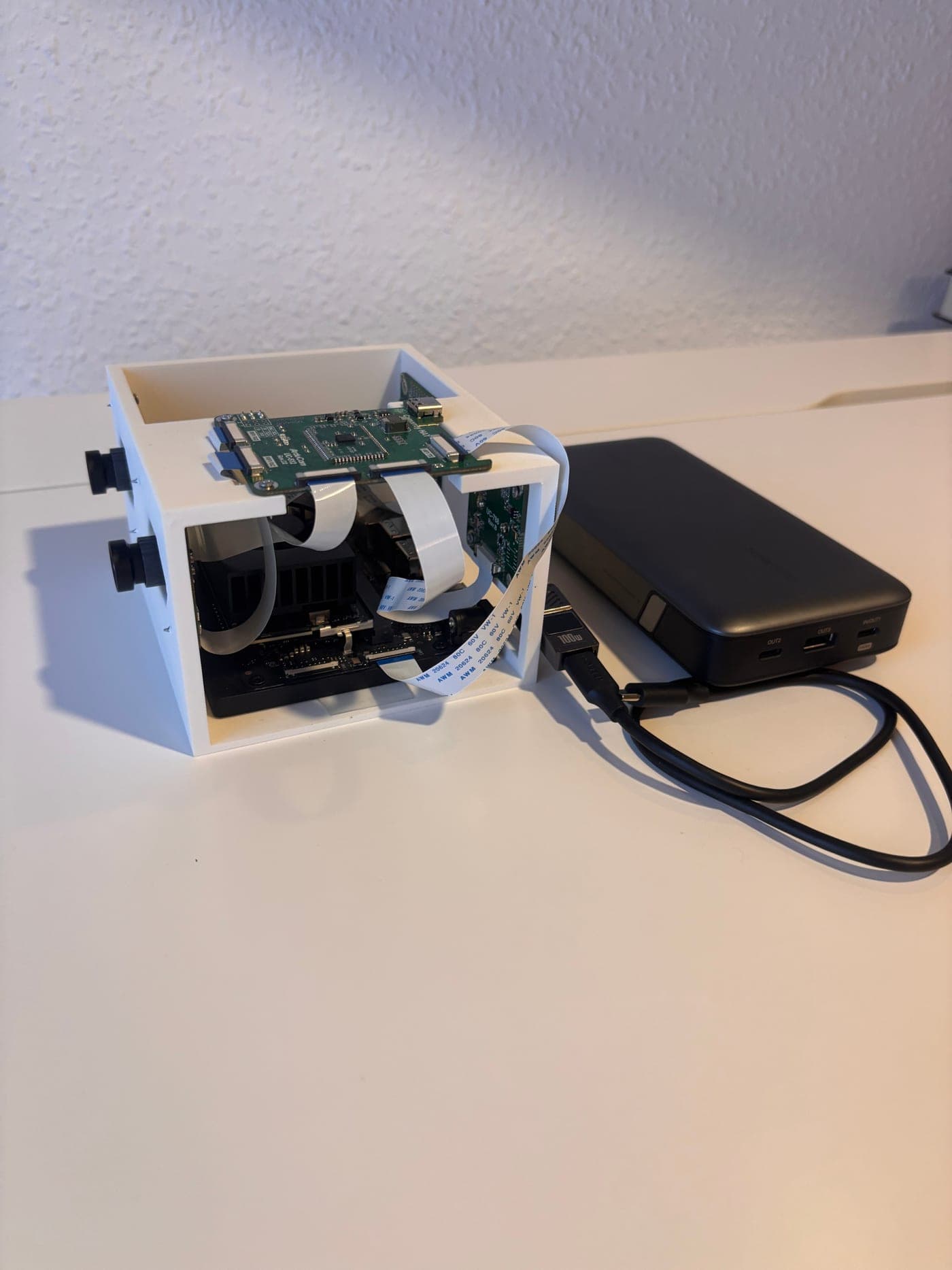 The rig: a Jetson Orin Nano and ArduCam CamArray HAT in a 3D-printed enclosure, powered by a USB-C battery pack